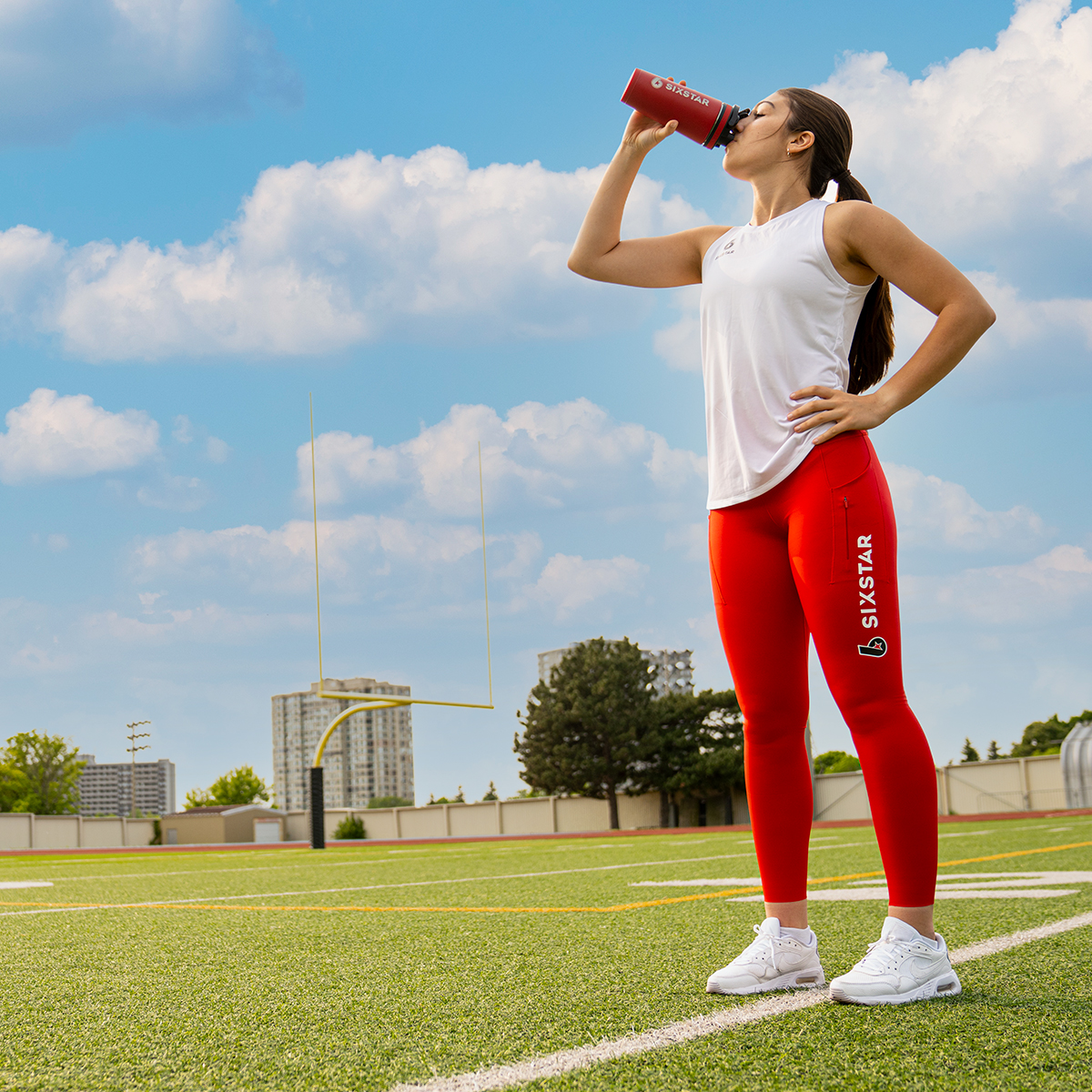Female athlete drinking protein after training