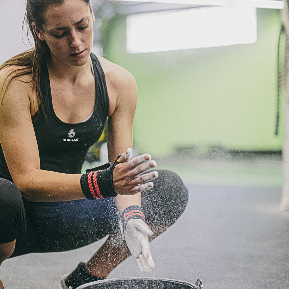 Athlete applying chalk to hands before workout