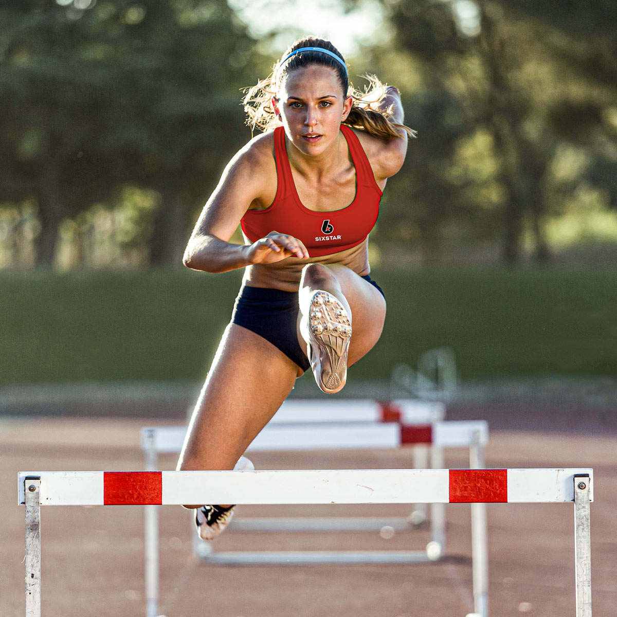 Athlete running hurdles